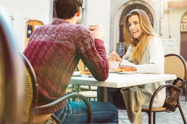 Couple dating at restaurant drinking coffee having fun and smiling