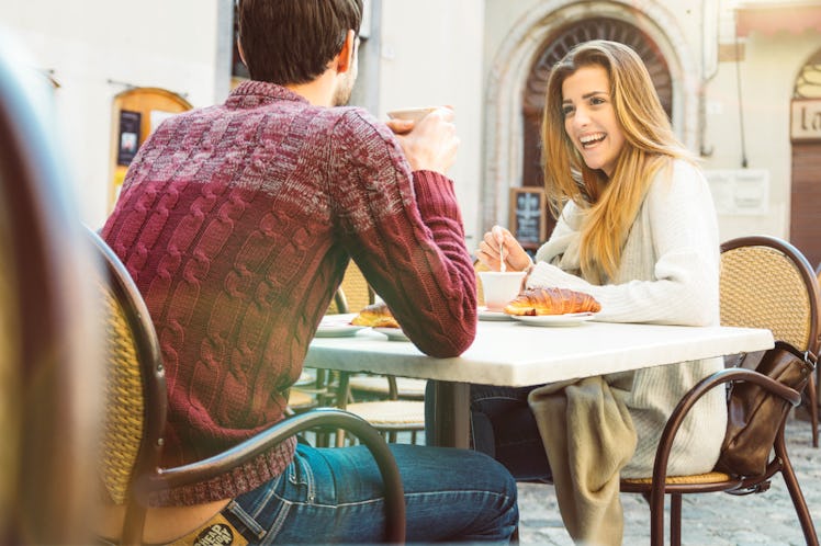 Couple dating at restaurant drinking coffee having fun and smiling