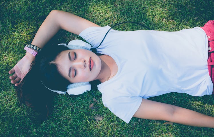 Women in music headphones pretty grass happy holidays.