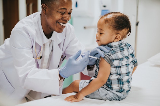 Toddler getting a vaccination by a pediatrician