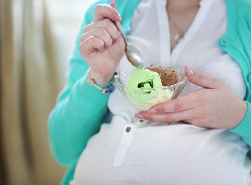 Pregnant woman with ice cream. Close up