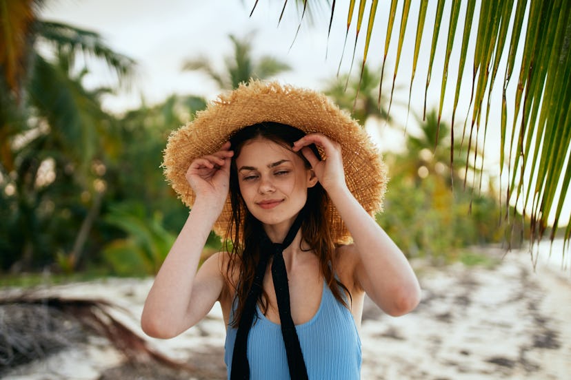 women on the beach with a hat nature summer                              