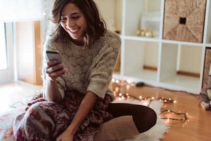 Woman texting in a smartphone - Christmas and Winter Season