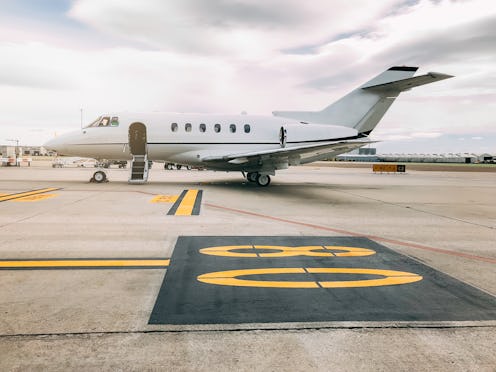 Private luxury jet at the airport terminal runway