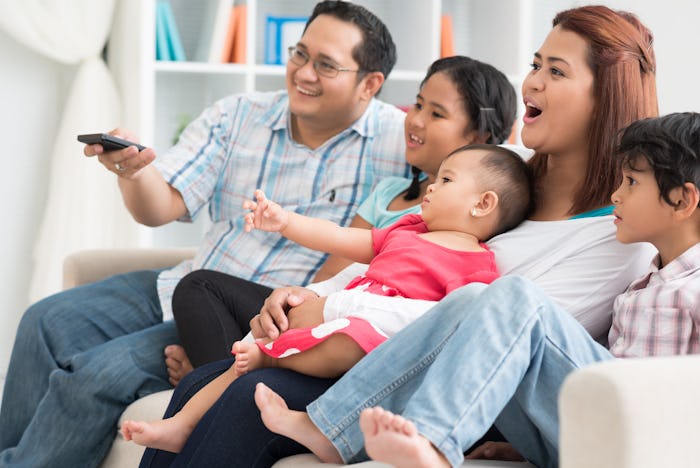 Image of a modern family watching TV at home