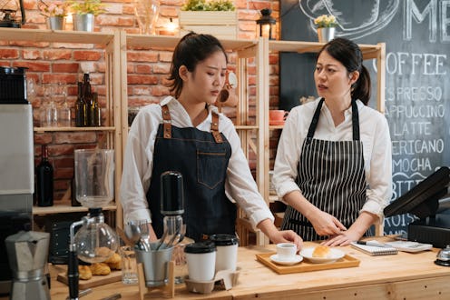 two emotional waitresses colleagues arguing with customer meal on counter table. coffee shop barista...
