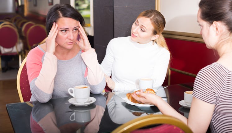 Worried women chatting together in the cafeteria