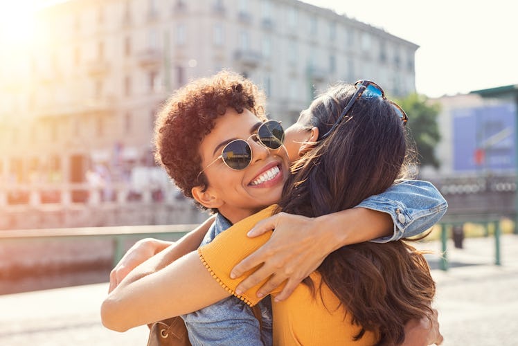 Friends hugging, who may have similar zodiac sign elements.