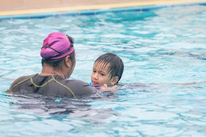 Boy having a swimming lesson.