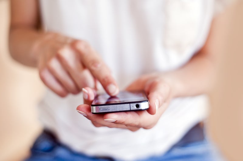 Young woman using apps on a mobile  touchscreen smartphone. Concept for using technology, shopping o...