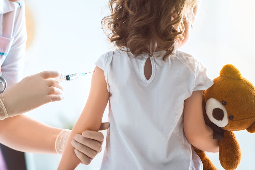 A doctor making a vaccination to a child