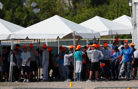 Migrant children stand outside the Homestead Temporary Shelter for Unaccompanied Children, in Homest...