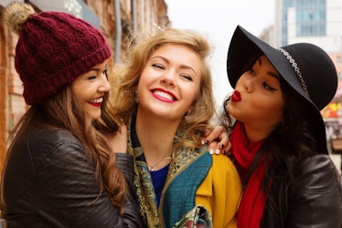 Young pretty  girls best friends smiling and having  fun, walking at the city. Shopping.  Wearing st...