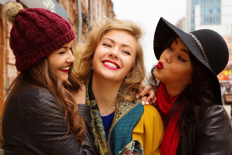 Young pretty girls best friends smiling and having fun, walking at the city. Shopping. Wearing st...