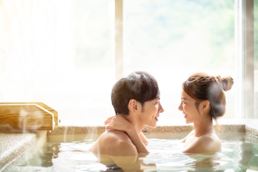 Young couple relaxing in hot springs 