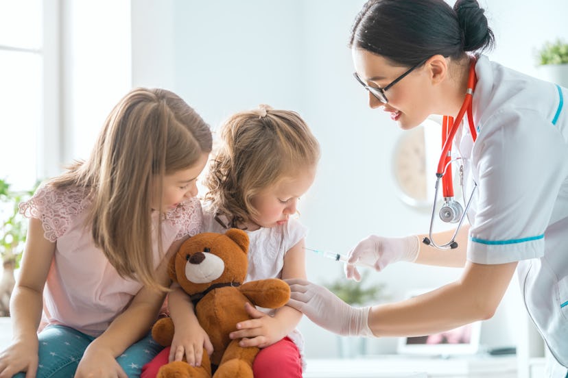 A doctor making a vaccination to a child