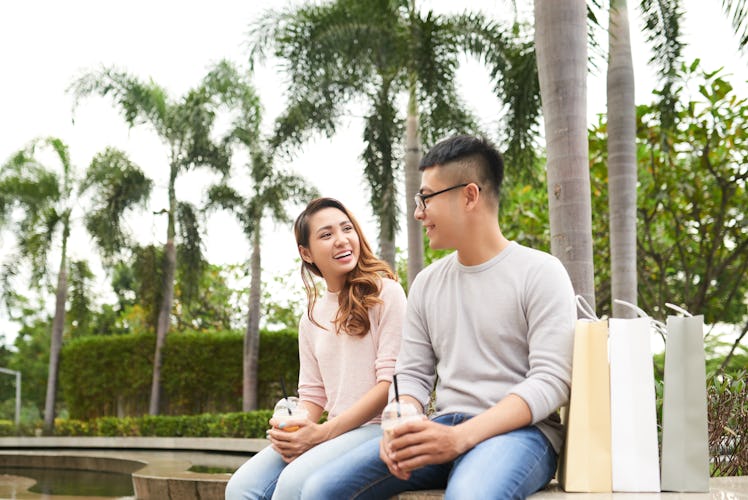 Young Vietnamese couple having first date in the park
