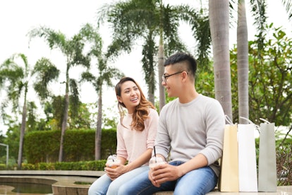 Young Vietnamese couple having first date in the park