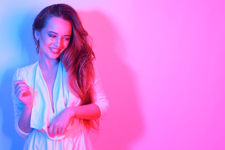 Fashion portrait of young elegant girl. Colored neon background, studio neon shot. Beautiful brunett...