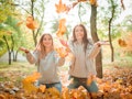 Close-up of beautiful girls, twins sisters, in autumn park