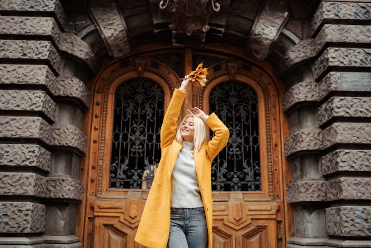 Beautiful elegant woman standing in the street in autumn , Fall concept