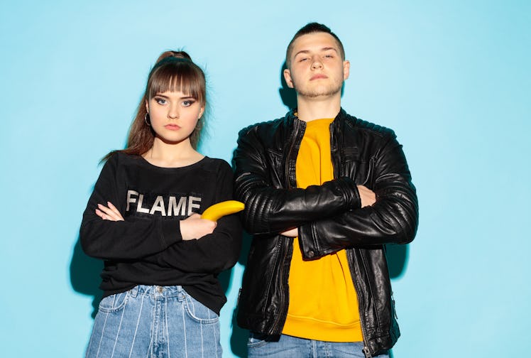 We are friends. Close up fashion portrait of two young cool hipster girl and boy wearing jeans wear....