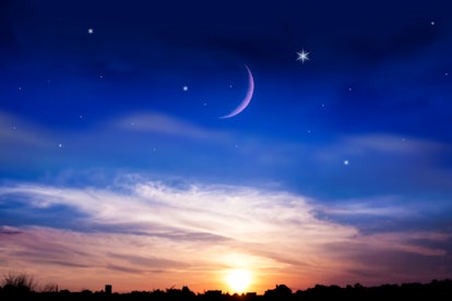 the night sky over the village .  New moon .  Religion background . The sky at night with stars. Ram...