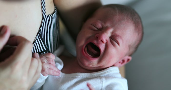 Newborn baby crying in mother arm