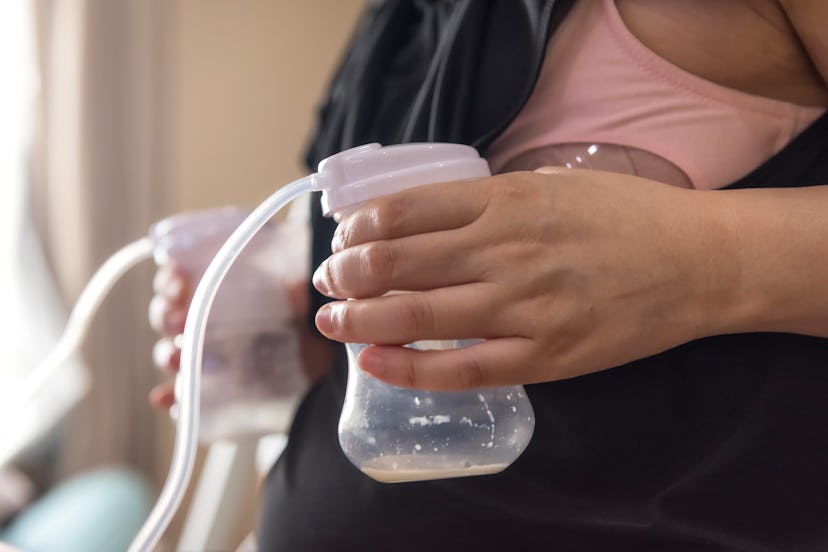 Mother first time pumped milk to Automatic breast pump machine after giving birth. breastmilk is the...