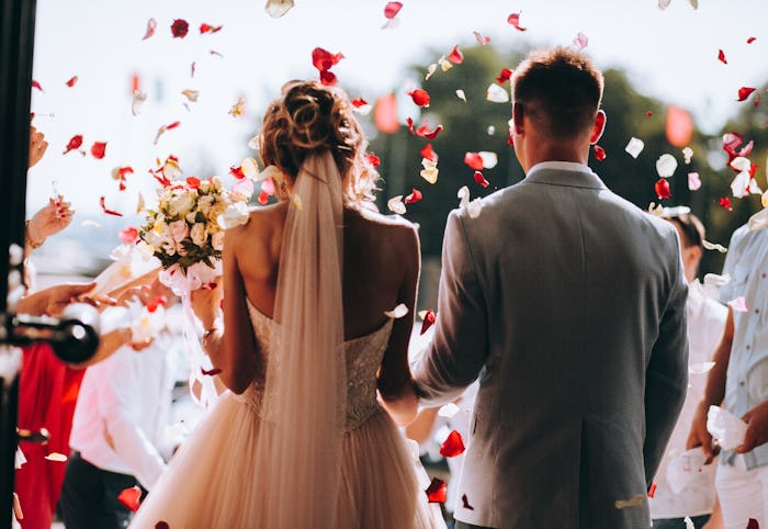 young couple in love.Wedding photo.Rose petals over a couple in love