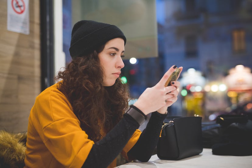 caucasian woman sitting indoor and using smart phone – technology, new generation, concentration