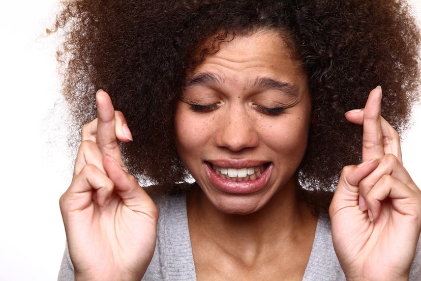 Afro lady keeping her fingers crossed