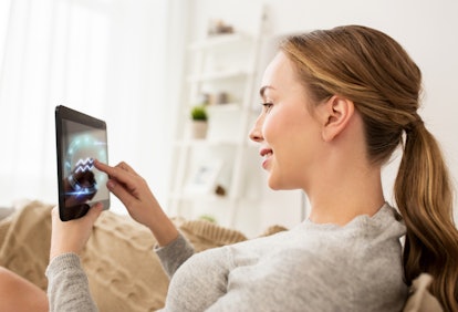 technology, astrology, horoscope and people concept - smiling woman with tablet pc computer and aqua...