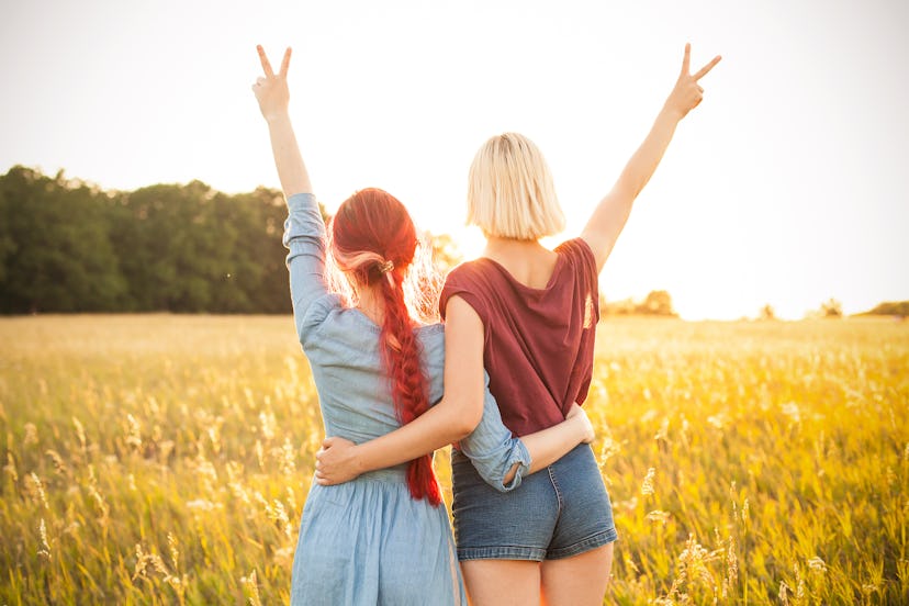 Two beautiful young women spend time together outdoors. Best friends
