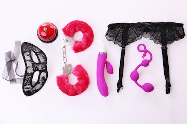 Sex toys and accessories on white background