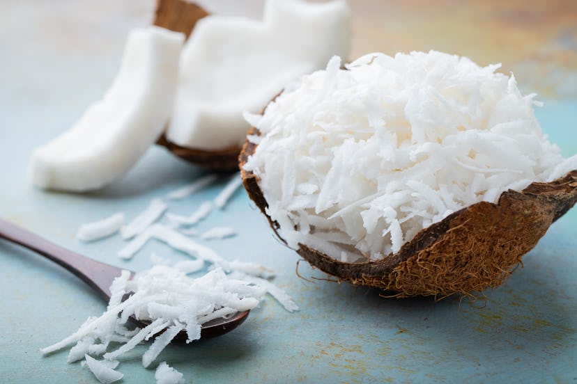 Coconut flakes in a shell on a blue background