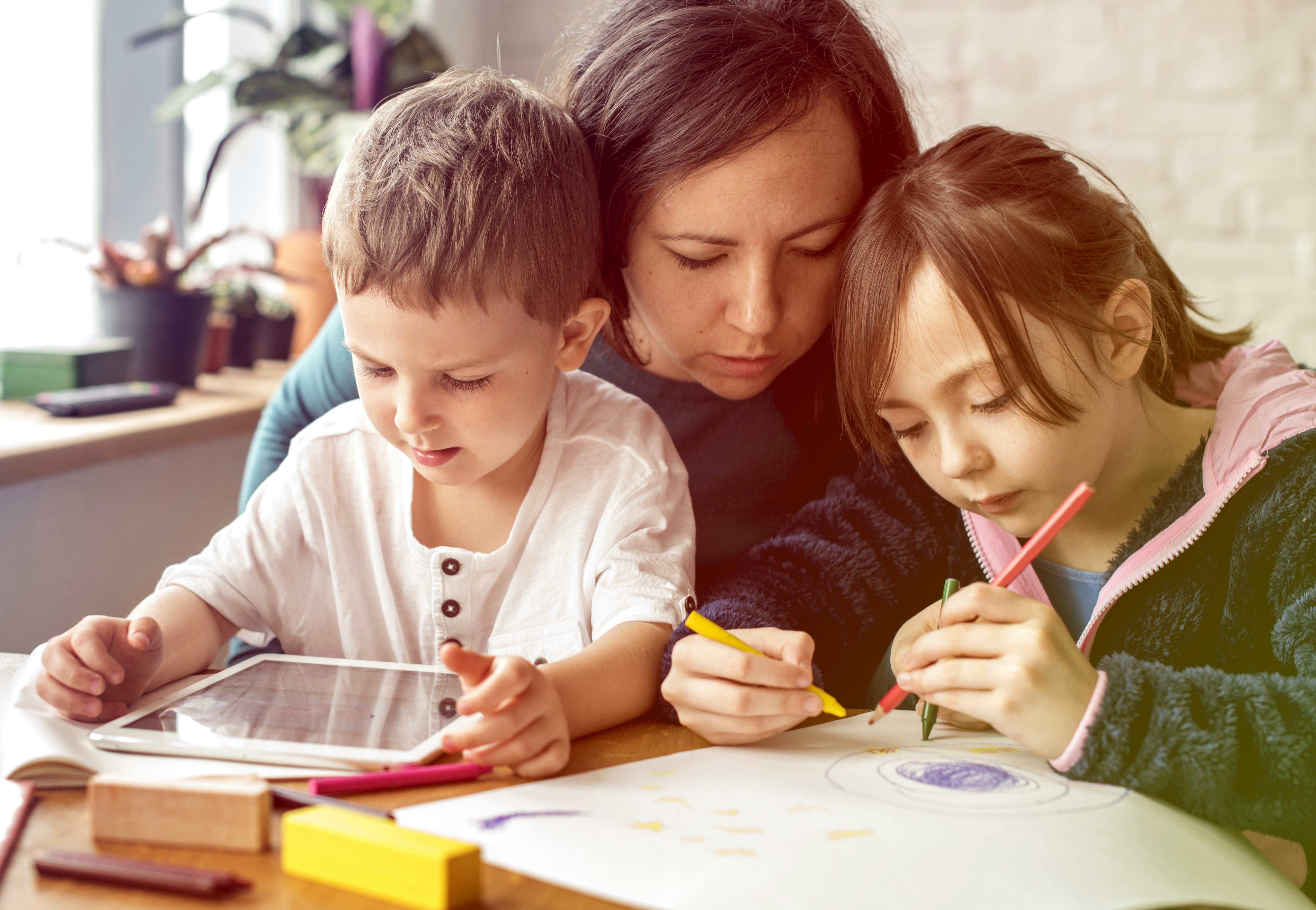 Mom and kids at homeschool learning together