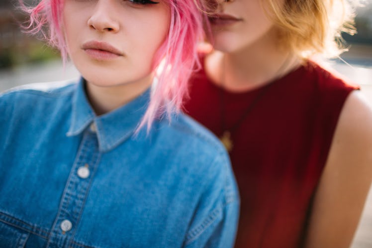 Lesbian couple. Cropped view of young girls hugging. Homosexual relationship romance.