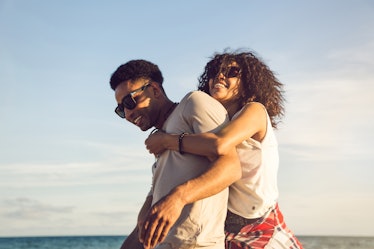 Happy afro american couple having fun together on a beach