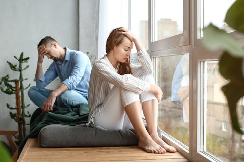 Sad couple after quarrel at home