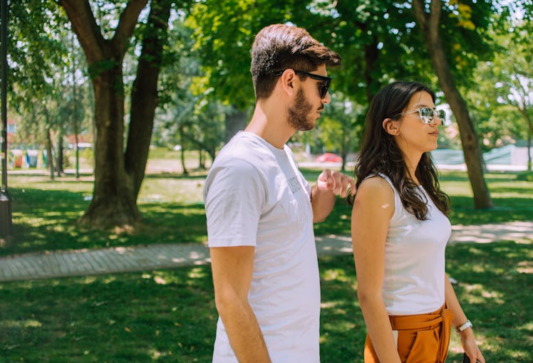 Full length portrait of happy couple, young man and woman on romantic date in nature