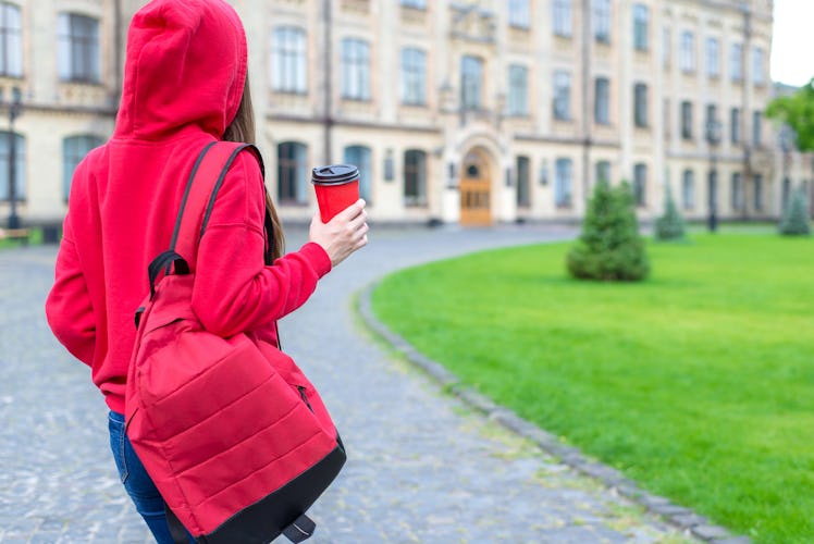 Back behind rear view photo of satisfied nice hipster person enjoying tea going to the building