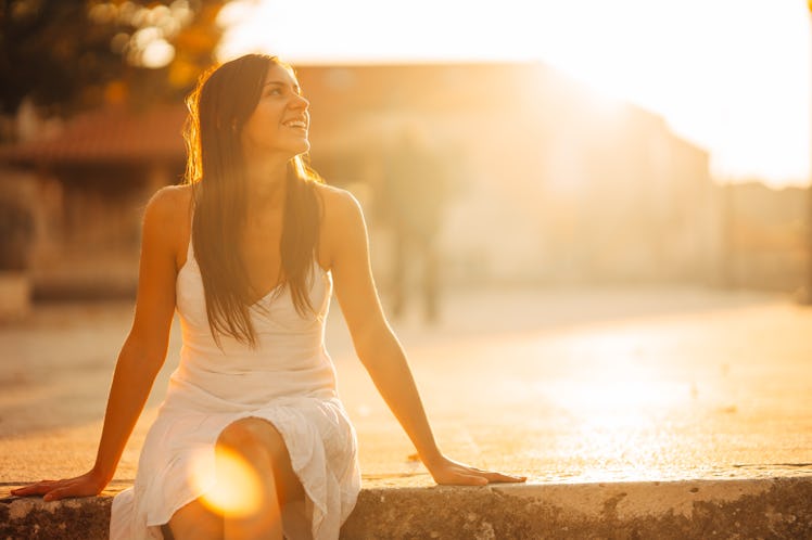 Carefree woman enjoying in nature,beautiful red sunset sunshine.Finding inner peace.Spiritual healin...