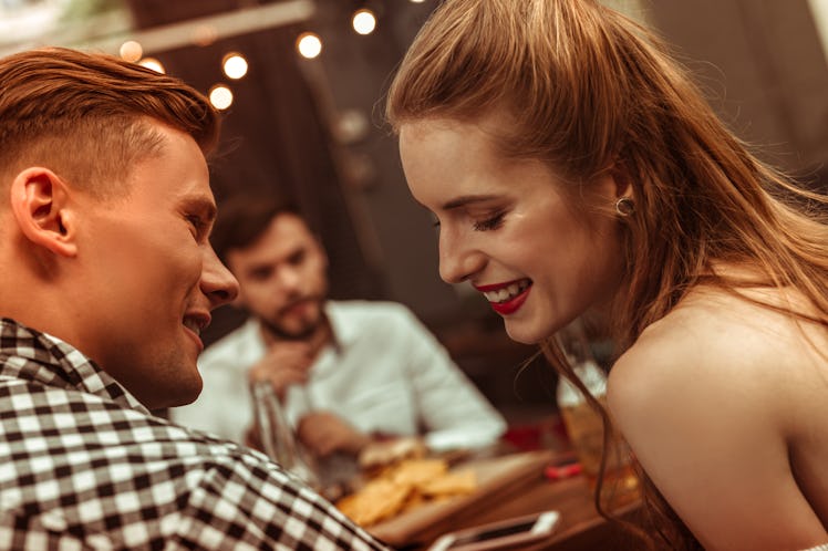 Flirting couple. Close-up face portrait of beautiful attractive young-adult cheerful joyful couple f...