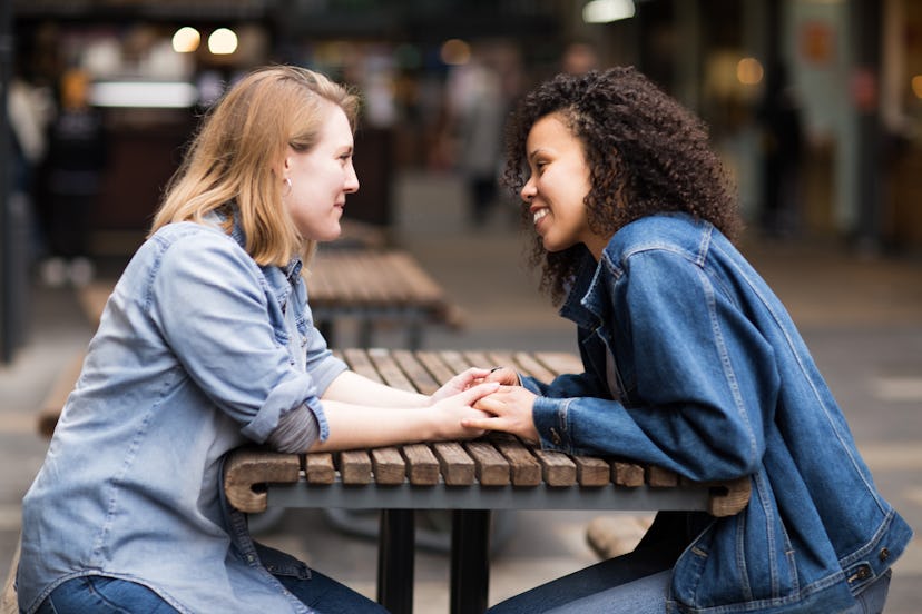 Happy lesbian couple sitting together talking