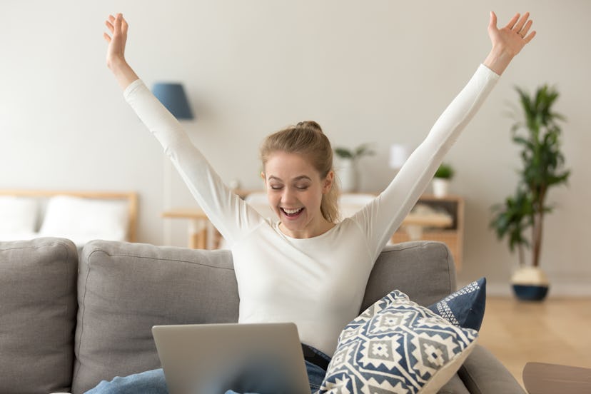 Excited smiling woman celebrating online win, victory, look at screen, using laptop at home, sitting...