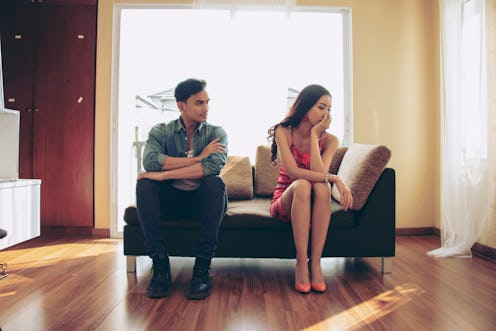 Unhappy couple sitting on couch after quarrel fight thinking of break up or divorce, black upset man...