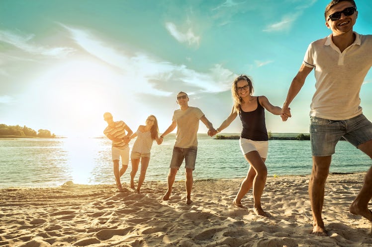 Happiness Friends fun on the beach under sunset sunlight in summer sunny day. Friendship concept.