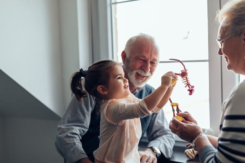 Grandparents playing with their granddaughter