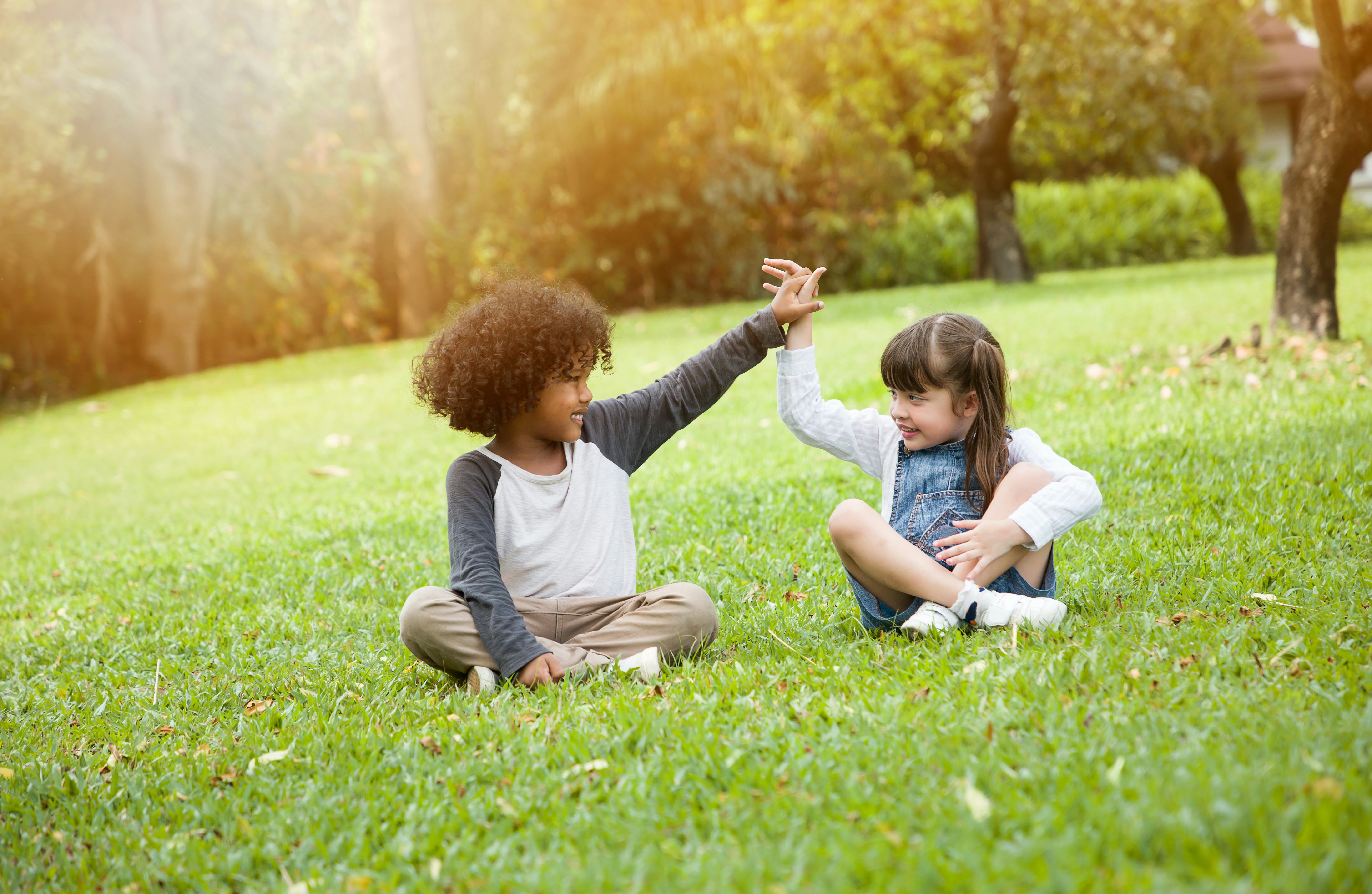 Children playing in the garden in summer day